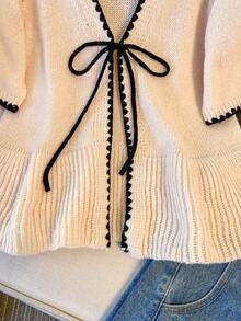 Franclia Áo khoác cardigan dáng rộng đơn giản mới, thắt nơ phía trước, cổ chữ V với viền gợn sóng tương phản, tinh tế và thu hút, chất liệu dệt kim mật độ cao mềm mại và ấm áp, phù hợp cho công sở hoặc mặc thường ngày, phối đồ nhẹ nhàng và thanh lịch, màu đào nhạt với độ bão hòa thấp tạo cảm giác thư giãn, áo len nữ năng động và dễ thương. - Nhiều màu - Xem 6