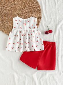 SHEIN Vintaside Kids Bộ đồ hai mảnh mùa hè cho bé gái, áo không tay cổ tròn và quần short đỏ. Màu sắc tương phản đỏ trắng tươi tắn, vải dệt, dáng rộng. Phong cách ngọt ngào, thanh lịch và đồng quê, họa tiết anh đào in khắp thân áo, sinh động và dễ thương. Phù hợp cho các buổi đi chơi hàng ngày, đi học, dự tiệc, tiệc sinh nhật, du lịch nghỉ dưỡng. - Đỏ - Xem 2