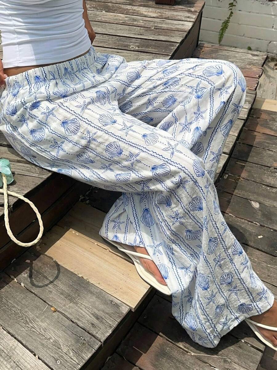 SHEIN ChillGRL 这款女童宽松直筒长裤适合春夏穿着,采用清新的蓝白配色,并饰以贝壳和海星印花。弹性腰带设计,穿着舒适自在。四季皆宜,是休闲外出和海滩度假的理想之选。 - 藍白色 - 查看 1