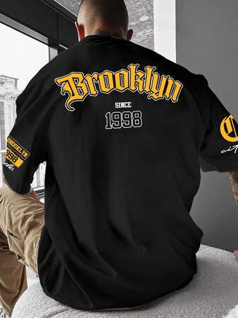 Manfinity Roghcode Camiseta Casual Masculina de Manga Curta com Ombros Caídos e Gráfico de Letra nas Costas, Verão