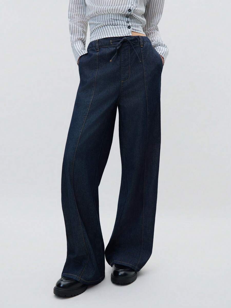Nöista Women's High-Waisted Drawstring Wide-Leg Jeans, Casual, Simple, And Practical. Made With A Deep Blue Washed Fabric And Visible Stitching, These Jeans Can Be Easily Paired With T-Shirts And Sweatshirts, Offering Both Practicality And Style. - Blue - View 1