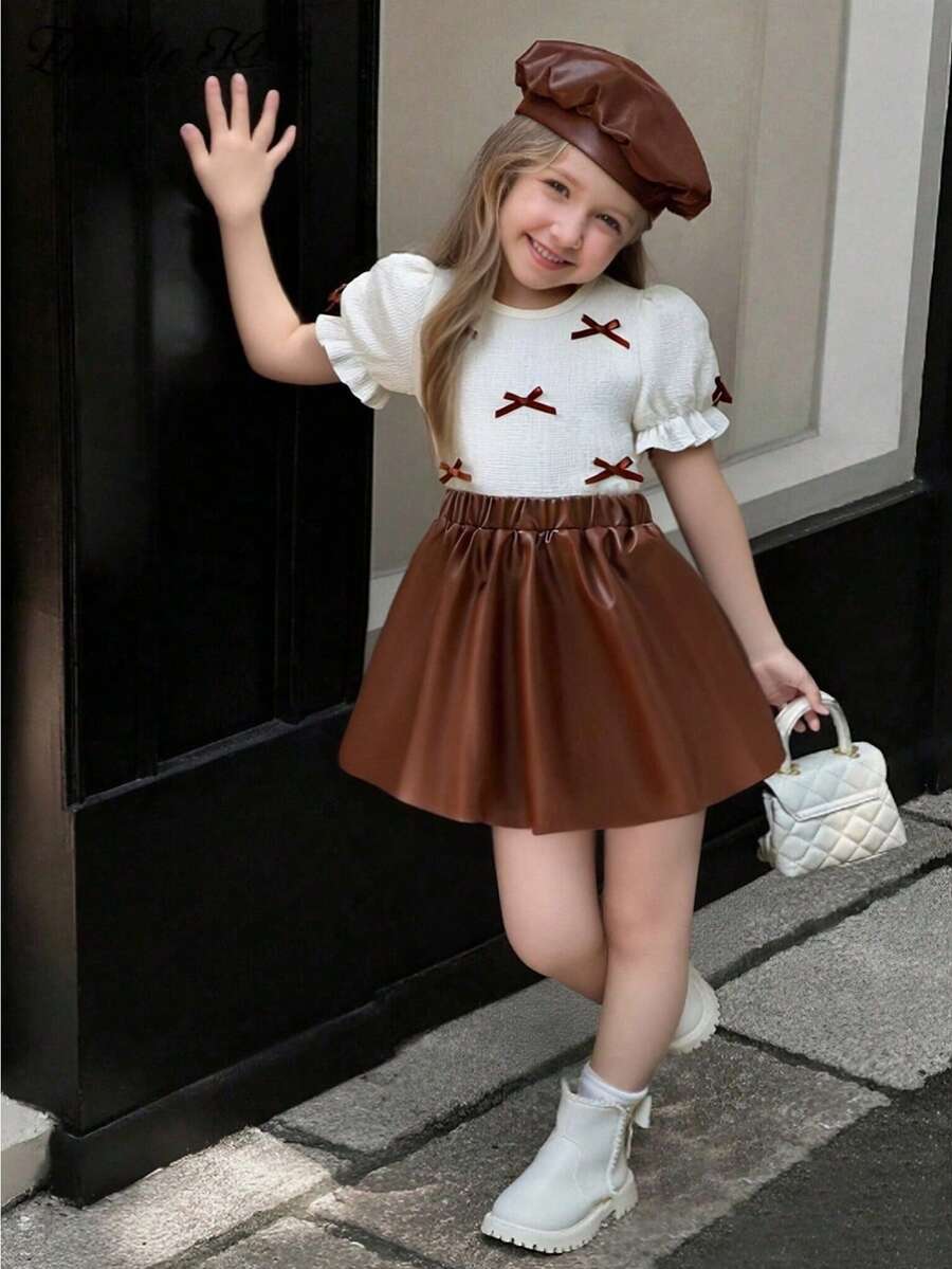 Elladie kids 夏季新款欧美时尚优雅少女套装,蝴蝶结装饰圆领泡泡袖T恤+PU半身裙,适合日常、通勤、上学等场合穿着。 - 棕色 - 查看 1