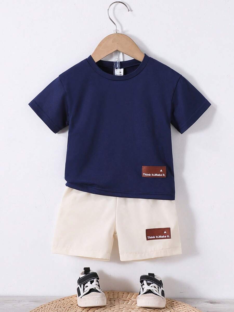 SHEIN 2 Pieces Unisex Newborn Neutral Set. It's A Set With A Brown Top And Apricot Shorts, Decorated With Letter Patches. Suitable For Summer, This Sportswear Is Perfect For Vacations, Parties, Outings, And As A Versatile Basic For School In Summer.Outfit Toddler Infant Outfits Unisex Summer. - Navy Blue - View 1