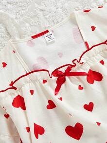 女童两件套睡衣：短袖上衣，饰有蝴蝶结和爱心印花，荷叶边下摆；宽松长裤，荷叶边下摆。 - 杏色 - 查看 6
