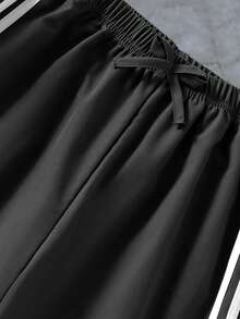 Pantalones largos de pierna ancha para niñas preadolescentes - Gris oscuro con rayas blancas, con cintura con cordón y decoración de lazo. Cómodos y holgados, adecuados para niños mayores. El diseño de la raya lateral agrega un toque a este pantalón largo casual y elegante. La tela es cómoda, lo que lo convierte en una opción de moda ideal para el uso diario de niñas preadolescentes. - Gris Oscuro - Ver 4