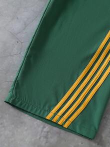 Sparklyn 女童阔腿长裤 - 深绿色底色搭配黄色条纹，配有抽绳腰带和蝴蝶结装饰。舒适宽松，适合年龄稍大的孩子。侧边条纹设计使这款长裤休闲时尚。面料舒适，是女孩日常穿着的理想之选。 - 綠色 - 查看 6