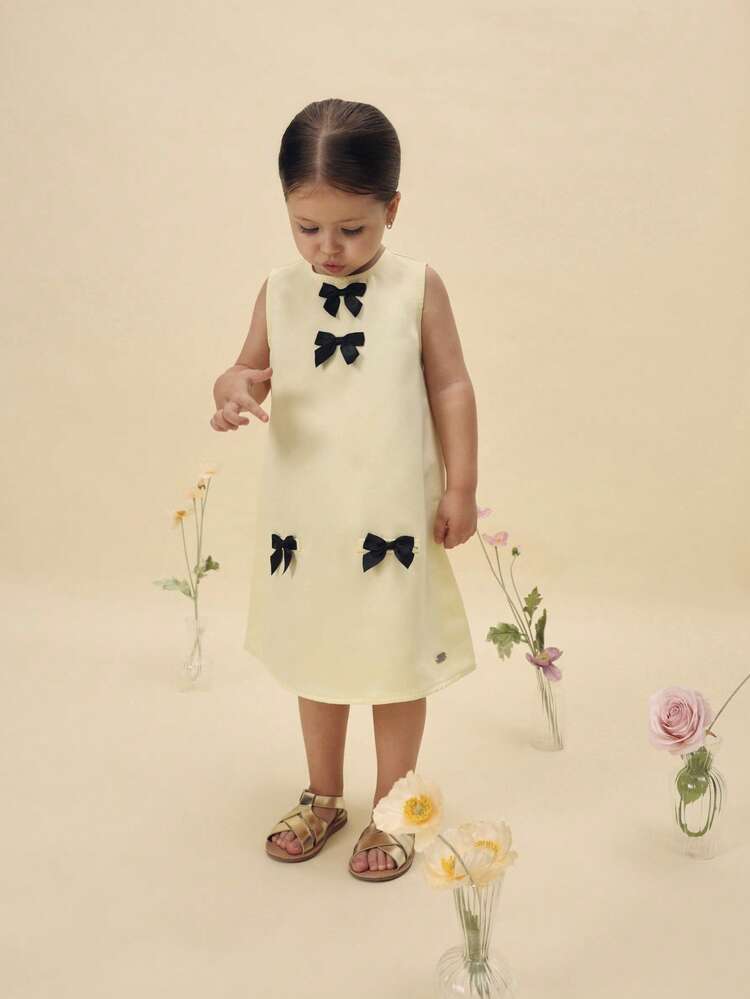 cream dress with black bows SUMWON Girls Sleeveless Shift Bow Decorations Satin Party Special Occasion Wedding Guest Mini Dress For Casual And Vacation Cream sequin