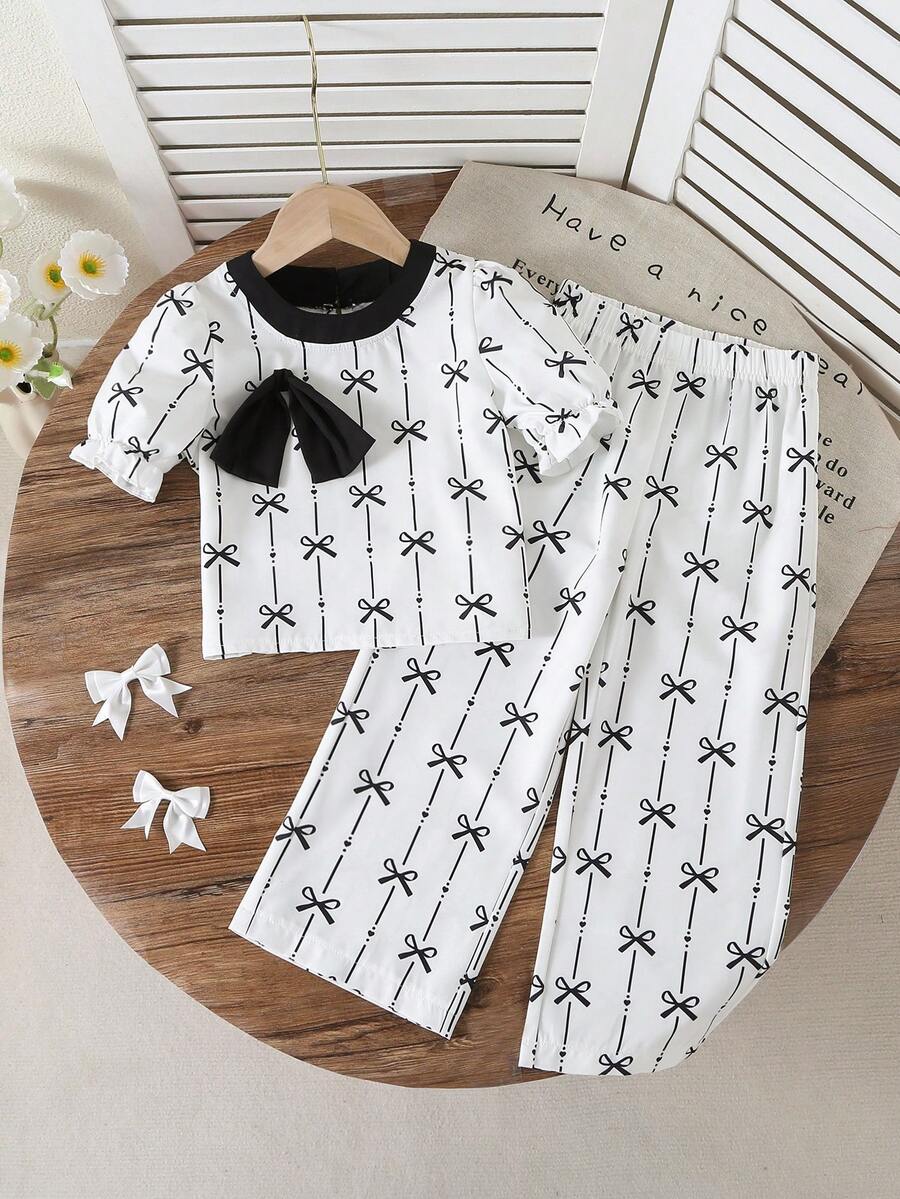 2pcs/Set, Young Girl Cute Minimalist Black Bowknot Print Bubble Sleeve Top & Bowknot Print Wide-Leg Pants Set - Fresh Summer Vacation Outfit, Perfect For Beach Trips, Travel & Summer Holidays - Black and White - View 1