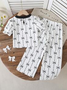 2pcs/Set, Young Girl Cute Minimalist Black Bowknot Print Bubble Sleeve Top & Bowknot Print Wide-Leg Pants Set - Fresh Summer Vacation Outfit, Perfect For Beach Trips, Travel & Summer Holidays - Black and White - View 2