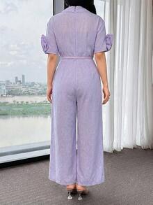 Modelyn جمبسوت نسائية أنيقة بتصميم بسيط ذات لون أحادي وياقة على شكل حرف V مزينة بزخارف زهرية ثلاثية الأبعاد وحزام واسع الساق - الأسود - مشاهدة 2