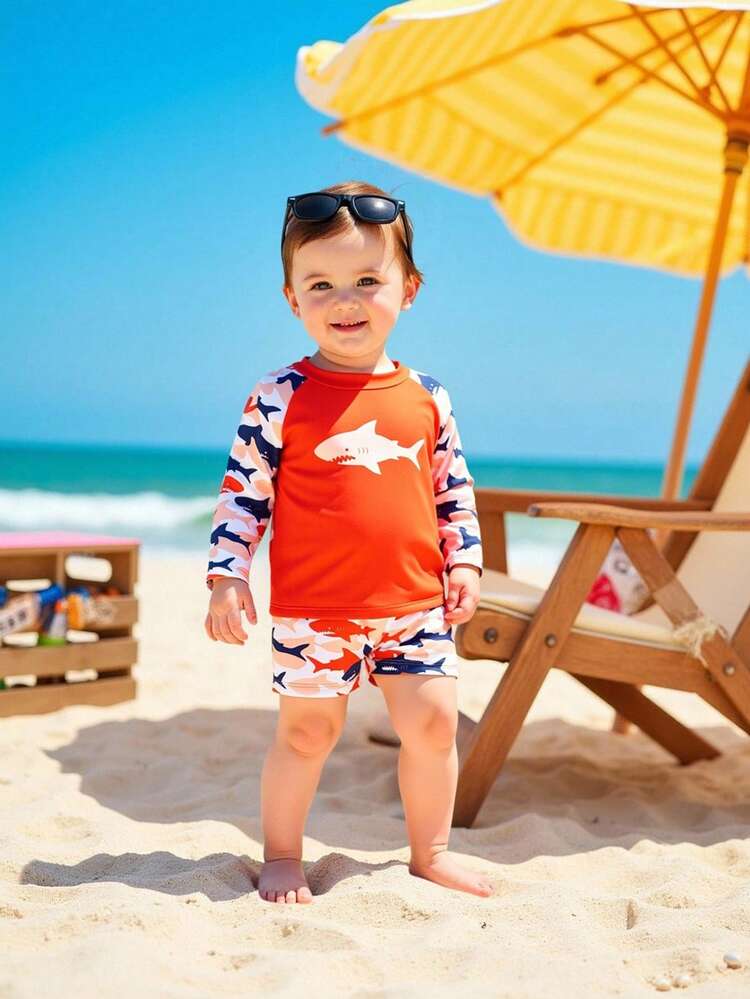 SHEIN Baby Boys Swimwear For Infants And Children (Boys) Swimwear Cartoon Multi-Color Shark Cartoon Pattern Knitted Fabric, Shark + Shoulder Strap Long-Sleeved Sun Protection Two-Piece Set, Two-Piece Top + Four-Corner Pants, Fashionable, Casual, Exquisite, Elegant And Ladylike, Suitable For Swimming, Suitable For Summer Vacation, Summer Beach, Seaside, Swimming Pool, Summer Party, Leisure Vacation Boy Rash Guard Set - Multicolor - View 1