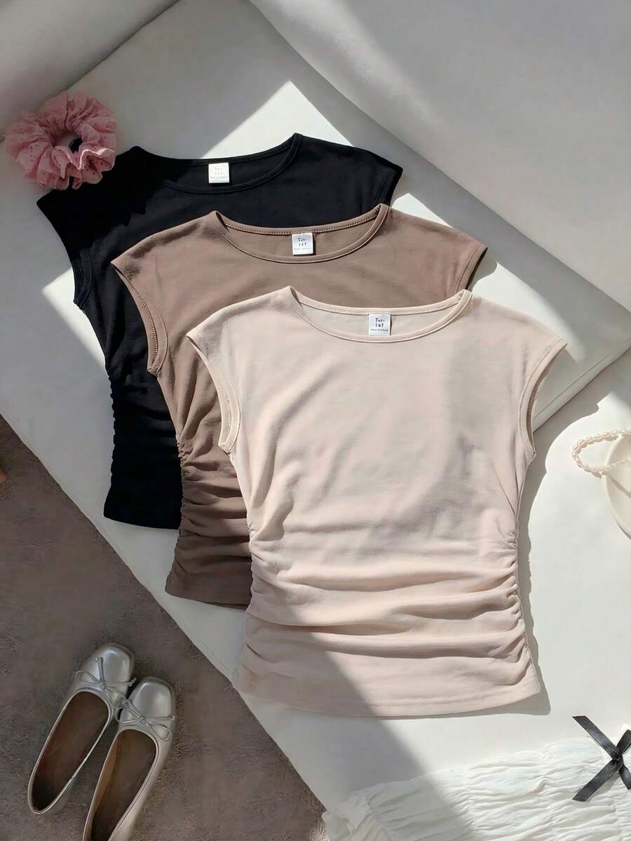 SHEIN Sparklyn 这是一套三件装的T恤，适合年轻女孩和青少年穿着。它们采用圆领一体式设计，宽肩无袖，修身剪裁，侧边略带褶皱。这些短袖上衣非常适合女孩们日常夏季穿着，而且很容易与其他服装搭配。 - 杏色 - 查看 1