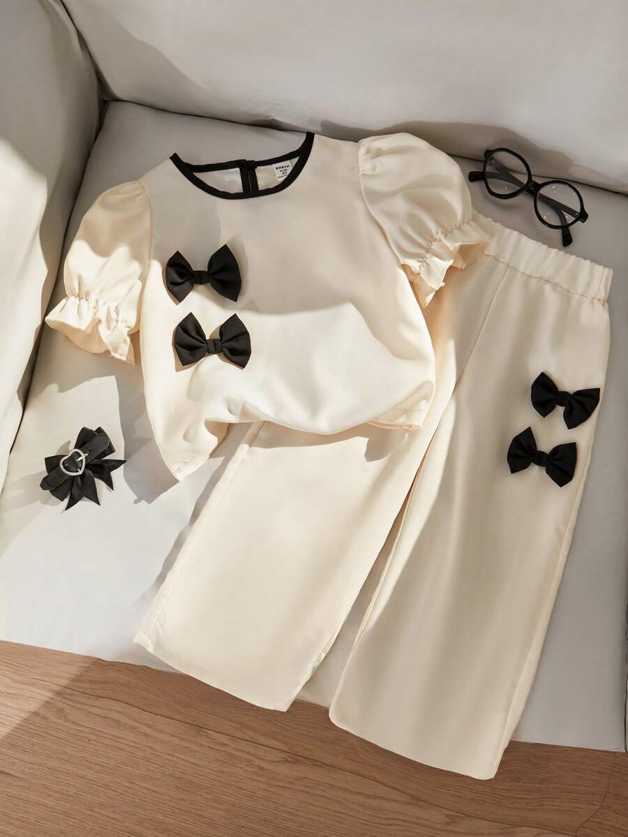 SHEIN Casuvi Kids 女童两件套 - 纯色梭织泡泡袖短袖上衣,撞色水滴领和蝴蝶结装饰,搭配宽松直筒裤,法式时尚风格,适合春夏休闲穿着 - 彩色 - 查看 1