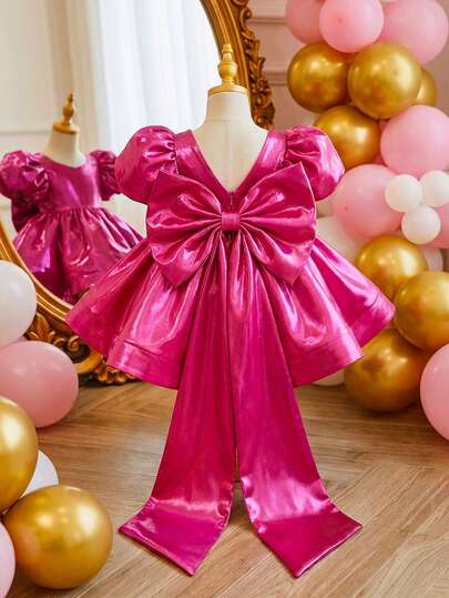 This Gorgeous And Elegant Princess Dress For Baby Girls Comes In Fuchsia And Purple-Red, Featuring A Huge Bow At The Back And A Trailing Bow Hem. It's Incredibly Cute And Perfect For Birthday Parties, Holiday Celebrations, Banquets, And Other Occasions – A Princess Dress Your Little One Has Always Dreamed Of!