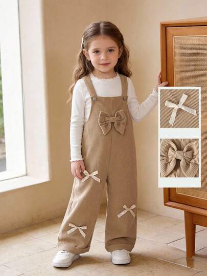 女童可爱风连体裤，春秋/秋冬款，大蝴蝶结设计，卡其色，宽松直筒裤型，灯芯绒面料，柔软舒适，适合上学、通勤、日常穿着。