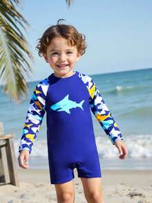 Baddräkt med dragkedja för spädbarn, tryck med haj och havsliv. Ett måste för sommarsemestern på stranden. Långärmad design, blå kontrastfärg, sött mönster med hajar och havsliv. Livlig och färgglad. Lämplig för söta pojkar att bära när de leker på stranden. - Kungsblått - Visa 3