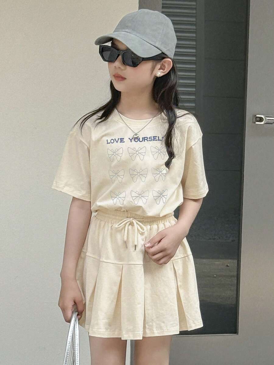 Dazy Kids Tween Girl Slogan Bow Print Round Neck Short Sleeve Casual T-Shirt And Pleated Mini Skirt Set - Apricot - View 1