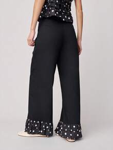 Nöista Pantalones de pierna ancha y cintura alta con bolsillos delanteros y volantes con estampado de lunares en el bajo. Estos pantalones combinan un estilo clásico con un detalle llamativo y divertido, ideales para la primavera, las vacaciones de primavera, la primavera, el estilo casual y la moda de vacaciones. - Negro - Ver 2