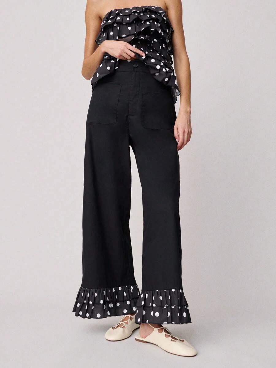 Nöista Pantalones de pierna ancha y cintura alta con bolsillos delanteros y volantes con estampado de lunares en el bajo. Estos pantalones combinan un estilo clásico con un detalle llamativo y divertido, ideales para la primavera, las vacaciones de primavera, la primavera, el estilo casual y la moda de vacaciones. - Negro - Ver 1