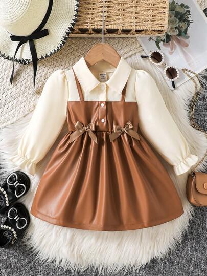 SHEIN Playful Pals 女婴立领泡泡袖两用A字连衣裙。经典A字廓形，适合各种体型的宝宝。独特的立领设计增添了一丝正式感，巧妙的泡泡袖设计则甜美俏皮。两用设计营造出视觉层次感。无论是外出还是居家休闲，这款连衣裙都能展现您宝宝活泼可爱的一面。