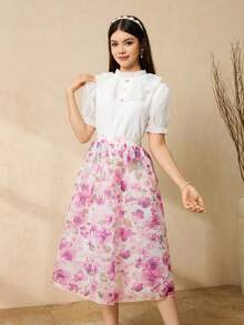 Bộ đồ thanh lịch, duyên dáng gồm áo tay phồng màu trắng và chân váy xếp ly eo in hoa, dành cho thiếu nữ. - Hồng - Xem 1