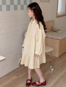 Dazy Kids Đầm dài tay màu trơn cho bé gái tuổi teen, cài cúc phía trước, vạt bèo nhún. - Màu vàng - Xem 3