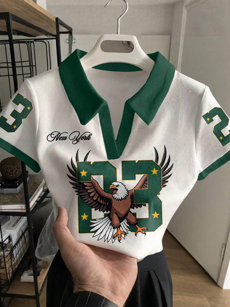 Rovax Blusa de manga corta casual de mujer con estampado numérico y águila, con ribete de contraste, para verano - Blanco - Ver 1