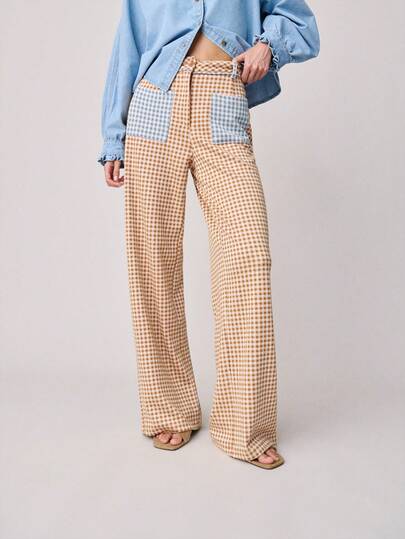 Nöista 中腰格纹长裤，配有撞色蓝色格纹口袋和腰部，裤腿宽松。适合春夏穿着。