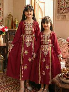 SHEIN Tween Girls' Burgundy Long Sleeve Robe. The Main Body Is Made Of Burgundy Fabric, With A Sheer Chiffon Hem That Provides A Flowing And Lightweight Feel. The Neckline, Front Placket, And Cuffs Feature Golden-Colored Printed Patterns, Decorated With Beaded Prints. A Matching Printed Belt Is Included At The Waist. The Design Combines Elements And Festive Dress Features. - Burgundy - View 10