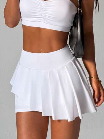 CourtClass Asymmetrisk plisserad kjol med shorts och fickor för kvinnor, lämplig för vardagskläder, löpning, yoga, gym, tennis, golf och andra sportaktiviteter, året runt