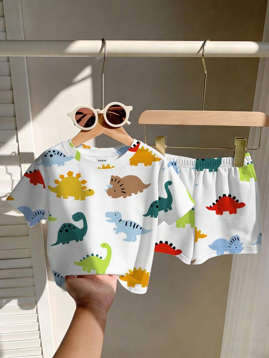 SHEIN Playful Pals 幼儿男童恐龙卡通印花圆领短袖T恤和配套弹力腰短裤套装，儿童服装，婴幼儿套装，婴幼儿短袖短裤套装，男婴套装，男婴T恤套装，恐龙元素。适合春夏穿着，夏季尺码，适合6个月至3岁宝宝。 - 白色 - 查看 1