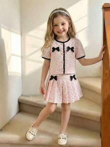 SHEIN This Two-Piece Set For Girls Features A Jacquard Short-Sleeved Top And A Pleated Skirt. An Elegant Two-Piece Spring/Summer Outfit, This Children's Jacquard Dress Is A New 2026 Spring/Summer Style Set For Girls, Featuring A Pink And White Jacquard Color-Blocked Short-Sleeved Top And A Pleated Skirt. It Includes A Delicate Black Bow Decoration And A Round Neck With A Single Row Of Pearl Buttons. This Two-Piece Set Is Perfect For Spring And Summer. - Multicolor - View 5