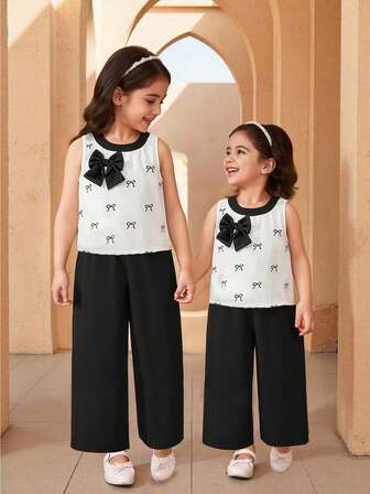 夏季新款优雅迷人女童套装，甜美蝴蝶结圆领无袖上衣搭配简约宽松阔腿直筒裤，适合日常通勤穿着。