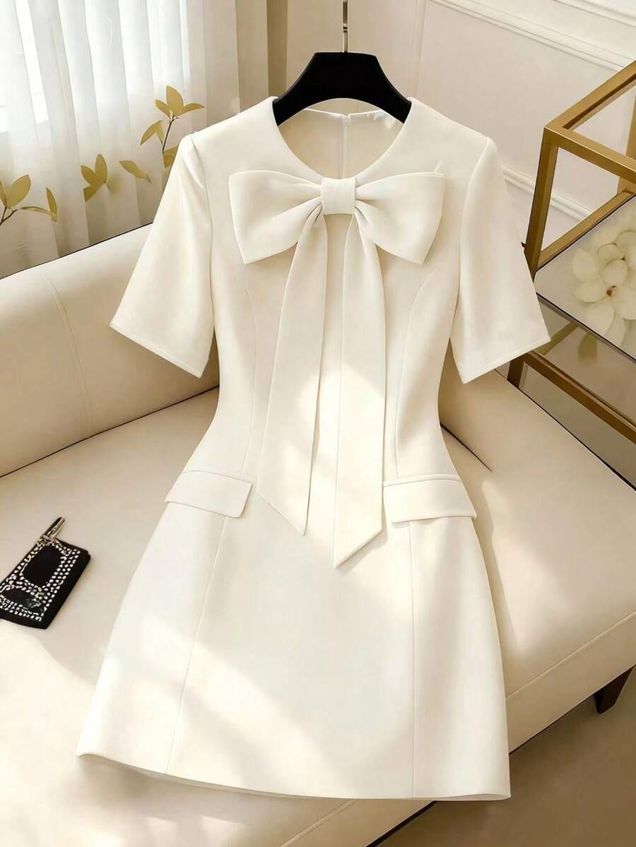 GlowEve Ivory White Round Neck Big Bow Tie Waist A-Line Dress With Fake Pocket Flap Decor, Elegant & Sophisticated, Suitable For Birthday Gift, Date, Party, Work, Professional Attire, Teacher Outfit, Student Style, Sweet Vibe, Travel & Vacation, Spring/Summer New Arrival, Short Sleeve A-Line Mini Dress - White - View 1