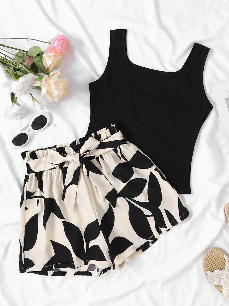 SHEIN Kids Summer Outfits  Squishy TEEN GIRL Black Tank Top & Khaki Leaf Print Loose Shorts Set, Vacation Style Suitable For Summer Two Piece Summer Outfits Two Piece Sets Cute Two Piece Sets Girls Two Piece Sets - Apricot - View 1