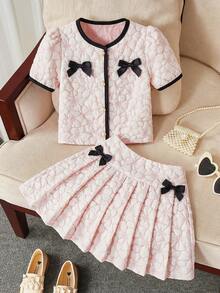 SHEIN This Two-Piece Set For Girls Features A Jacquard Short-Sleeved Top And A Pleated Skirt. An Elegant Two-Piece Spring/Summer Outfit, This Children's Jacquard Dress Is A New 2026 Spring/Summer Style Set For Girls, Featuring A Pink And White Jacquard Color-Blocked Short-Sleeved Top And A Pleated Skirt. It Includes A Delicate Black Bow Decoration And A Round Neck With A Single Row Of Pearl Buttons. This Two-Piece Set Is Perfect For Spring And Summer. - Multicolor - View 7