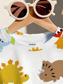 SHEIN Playful Pals 幼儿男童恐龙卡通印花圆领短袖T恤和配套弹力腰短裤套装，儿童服装，婴幼儿套装，婴幼儿短袖短裤套装，男婴套装，男婴T恤套装，恐龙元素。适合春夏穿着，夏季尺码，适合6个月至3岁宝宝。 - 白色 - 查看 4