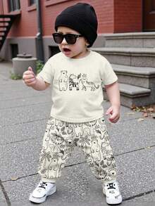 SHEIN 2 pièces/Set T-shirt à manches courtes ample et confortable et pantalon pour bébé garçon, convient pour le printemps/été. Imprimés mignons et classiques d'animaux de la bande dessinée comme zèbre, tigre, ours brun, lion, écureuil, hippopotame, éléphant - Multicolore - Voir 2