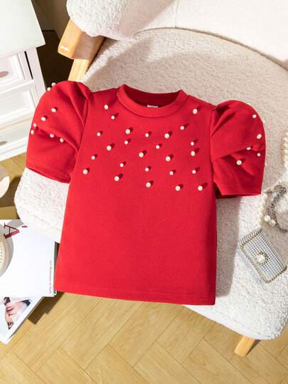 Elladie kids Young Girl's Red Short Sleeve T-Shirt, Featuring Sweet Puff Sleeve Design, Structured And Adorable. Embellished With Delicate Beaded Decor, Adding Elegance And Fashionable Touch. Comfortable To Wear, Suitable For Summer Casual Outfits Or Party Occasions. The Vibrant Red Color Makes The Little Girl Confidently Shine And Radiate Childlike Charm. Girls Red Top Puffy Sleeve Top Red Top With Pearls