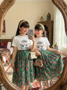 SHEIN 2pcs/Set Girls' Traditional Arabic Clothing, Floral Print Decor White Short Sleeve T-Shirt (Featuring Floral Pattern + Intricate Eye Design) + Vintage Dark Green Floral Pleated Skirt Set - Multicolor - View 1