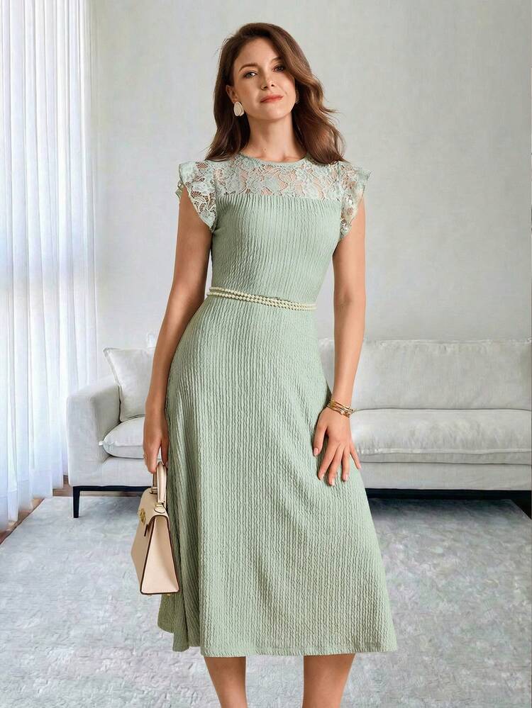 This Elegant Summer Dress For Women Features A Refreshing Mint Green Color. Its Soft Texture Exudes A Soothing Atmosphere, Providing A Gentle Base For Any Stylish Look. The Floral Pattern Combines Lace Trim With Textured Fabric, Showcasing Delicate Details And A Refined Sense Of Fashion. The Design Includes A Round Neck, Short Flutter Sleeves, A Fitted Waist, And A Full Skirt. A Pearl Belt Accentuates The Figure, While The Flowing Skirt Adds An Elegant Touch. Suitable For Spring And Autumn, It Can Be Paired With Light-Colored Accessories To Brighten The Look Or Layered With A Cardigan For Added Femininity. Perfect For Casual Gatherings Or Everyday Outings, This Dress Combines The Refreshing Mint Green With Sophisticated Lace Details, Making It A Versatile Wardrobe Staple That Blends Femininity And Practicality.