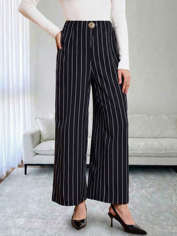 These Elegant Women's Trousers Feature A Sophisticated Navy Blue Base With White Vertical Stripes, Perfectly Complementing The Refined Atmosphere Of The New Year While Exuding A Sleek And Stylish Feel. The Simple Vertical Stripe Pattern Visually Elongates The Legs And Adds A Touch Of Sophistication. The High-Waisted, Wide-Leg Design, Adorned With Gold Buttons For Added Detail And Quality, Offers Both Comfort And A Flattering Silhouette. Suitable For Spring And Autumn, These Trousers Can Be Paired With A White Top For An Elegant Look Or Layered With A Jacket For Added Depth. Perfect For Both Work Commutes And Casual Gatherings, These Trousers Showcase Professional Style At Work While Also Highlighting A Polished And Sophisticated Taste Thanks To Their Striped Design. A Versatile And Stylish Addition To Any New Year's Wardrobe, These Trousers Are Both Practical And Chic.