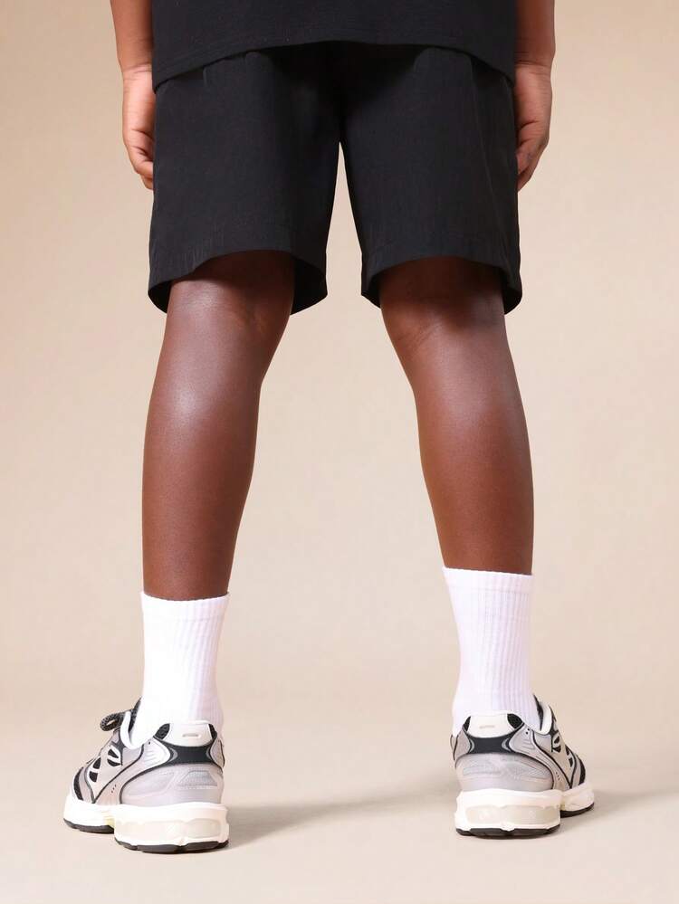 Pantaloncini in nylon con coulisse e dettaglio logo