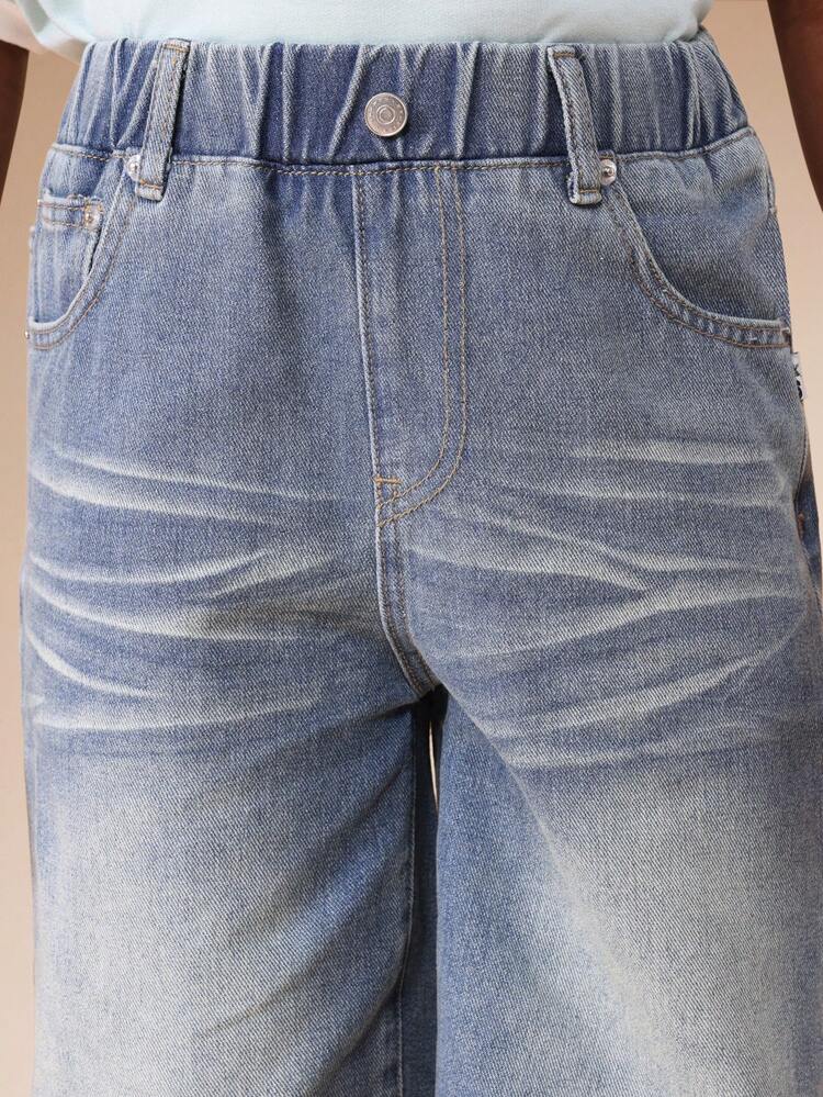 Pantaloni in denim a gamba larga con lavaggio medio