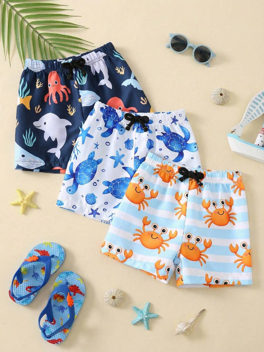 SHEIN Bộ 3 món quần áo trẻ em unisex, bộ đồ bơi và quần short đi biển họa tiết hoạt hình đại dương cho bé trai, thích hợp cho bãi biển, hồ bơi, khu nghỉ dưỡng spa.