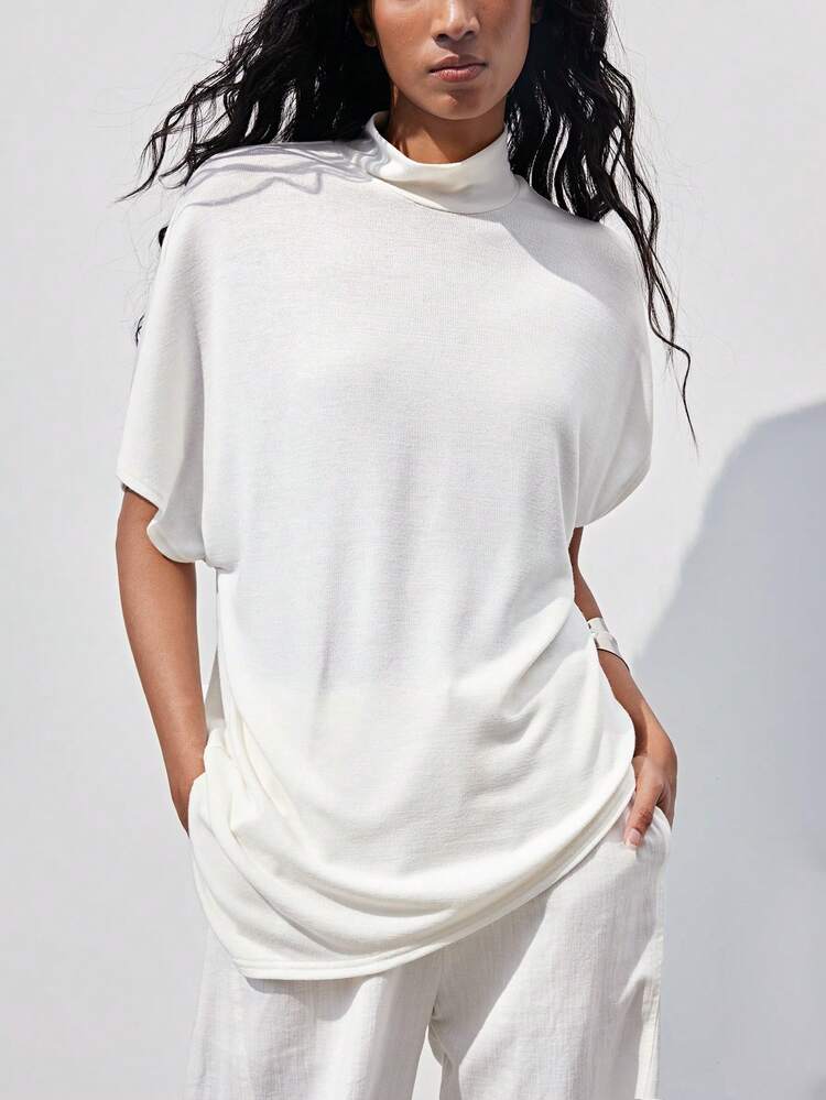 SHEIN Maija Camisa casual de mujer para ir al trabajo, diseño de unicolor, cuello alto, emparejada con mangas tipo murciélago holgadas y bajo asimétrico, elegante y cómoda. Adecuada para el trayecto diario y ocasiones casuales, que muestra confianza femenina y un estilo único