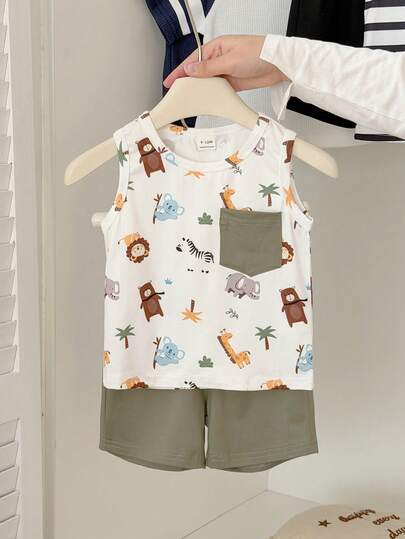 SHEIN Babyboy Summer Cartoon Animal Print Round-Neck Sleeveless Vest Paired With Pure Green Shorts Two Pieces Set, Pure White Base Color With Jungle Animal Full-Printed Patterns, Simple, Comfortable, Lively And Cute Style, Knitted Fabric, Fit Well, Green Patch Bag On The Side Adds Practical Details, Perfect For Visiting Wildlife Parks, Participating In Parent-Child Nature Study Tours, Outdoor Adventures, Comfortable At Home, And Happy Party Time.