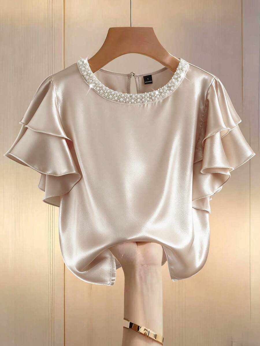 Modelyn Blusa elegante de manga corta con cuello redondo, volantes en el bajo y perlas falsas de unicolor para mujer - Albaricoque - Ver 1