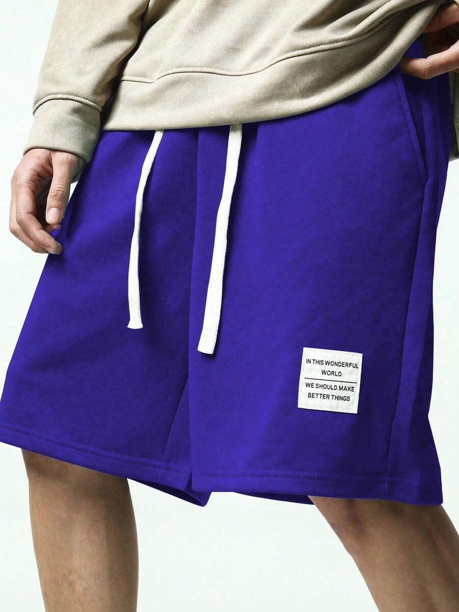 Manfinity Hypemode Quần short nam màu xanh dương đậm, có chi tiết chữ cái và dây rút, cạp chun, quần short nam dáng rộng, quần short phong cách đường phố, quần short hai lớp. - Màu tím - Xem 1