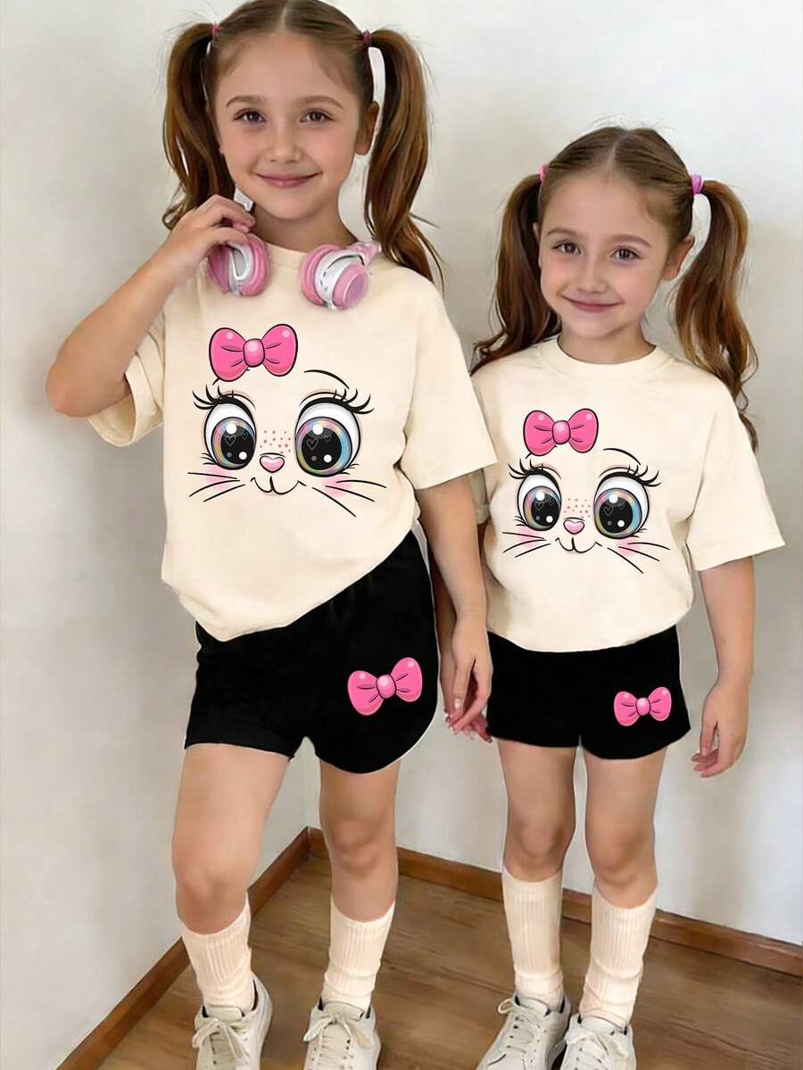 2件套女童时尚可爱蝴蝶结小猫印花圆领短袖T恤上衣和短裤套装，杏色上衣搭配黑色短裤，适合春夏休闲外出穿着。 - 彩色 - 查看 1